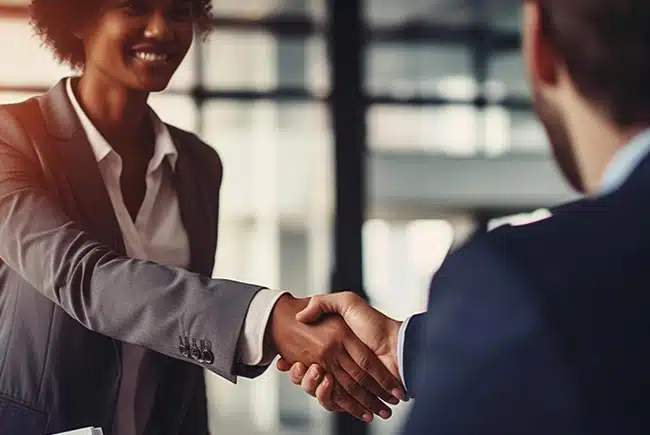Two business people greeting each other with a handshake.