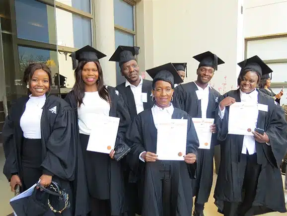 A group of PnS Academy learners who have just graduated and they are holding their certificates.